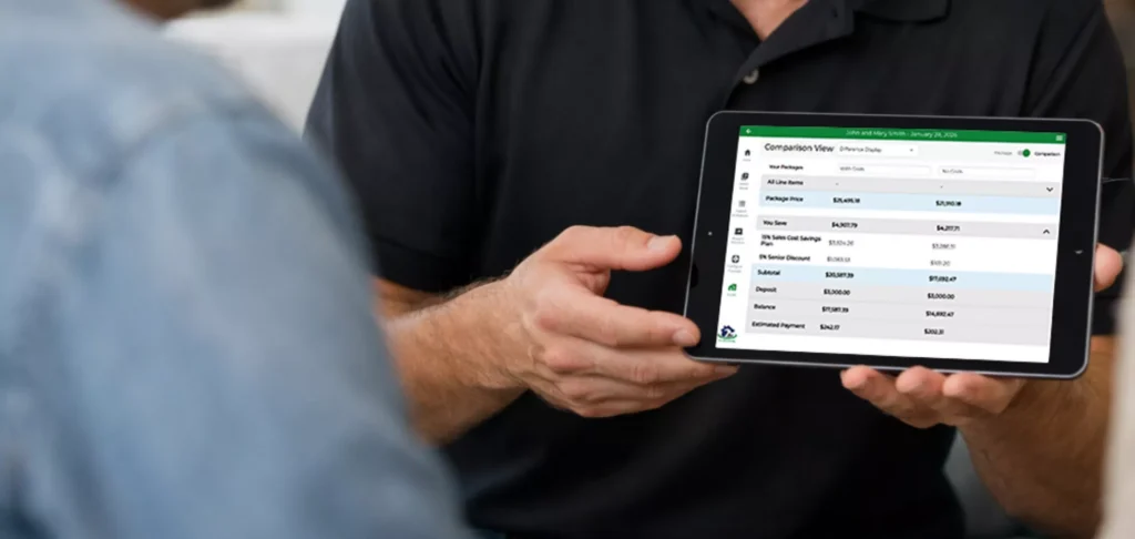 Sales Person in a Black Polo Holding an iPad Showing a Quote from Paradigm Vendo - 2200x1045